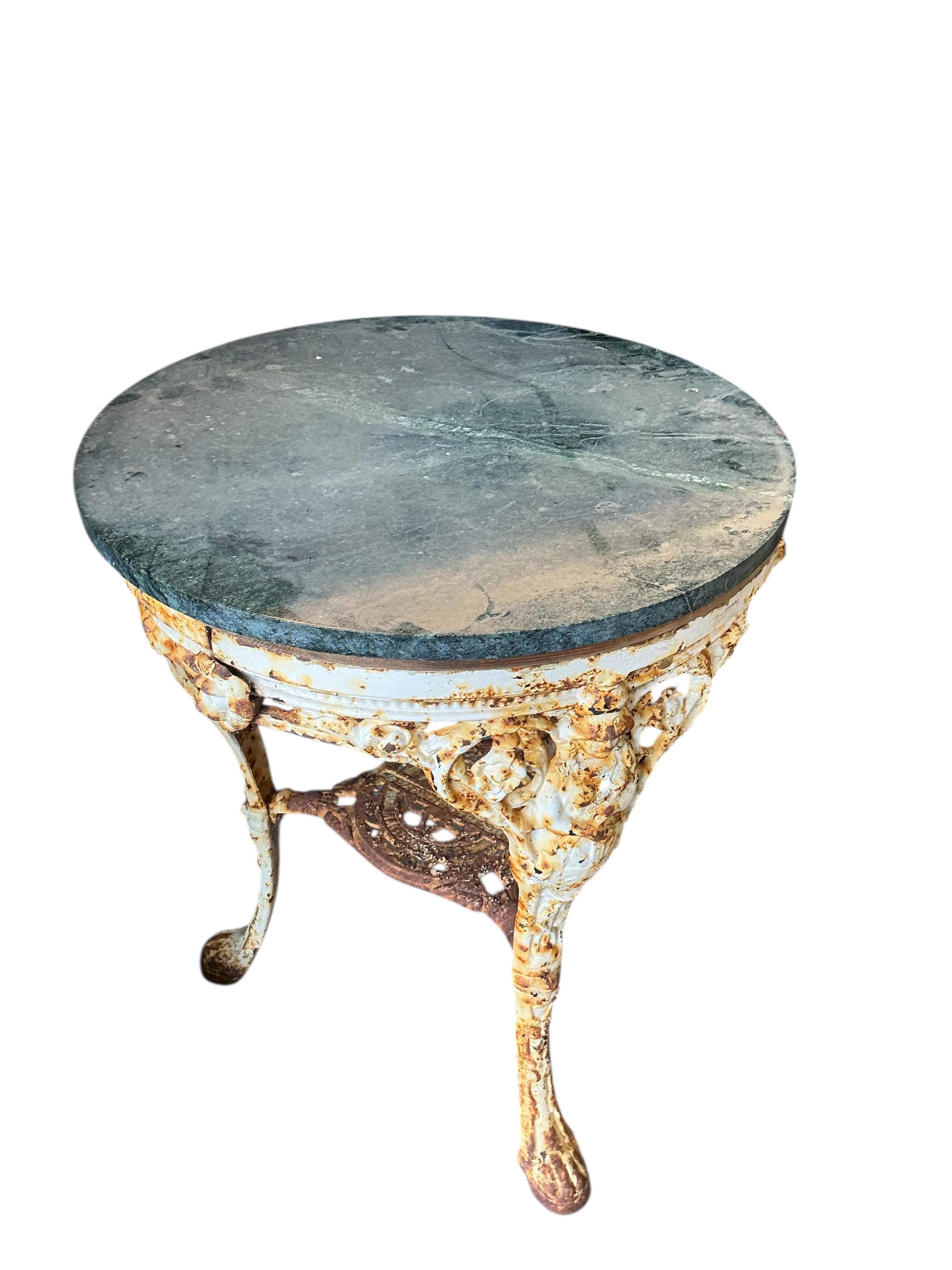 A Victorian painted cast iron Britannia pub table with green marble top, diameter 60cm, height 77cm